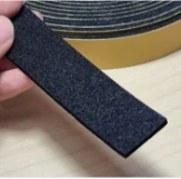 Black adhesive-backed EPDM foam strip with yellow release liner